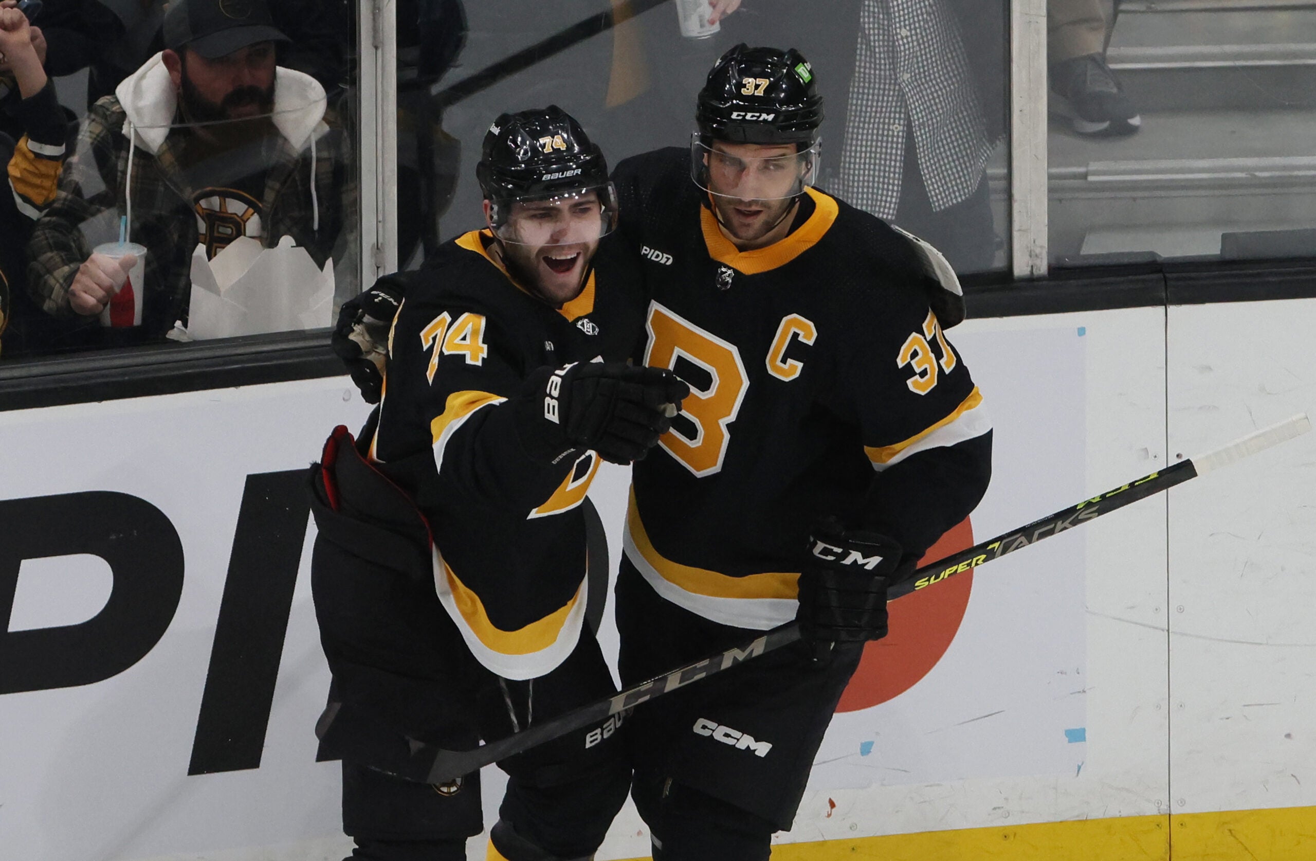 Boston Bruins Jake DeBrusk (L) celebrates his goal against the Ottawa Senators Goalie with teammate Patrice Bergeron during the first period of play at TD Garden.
