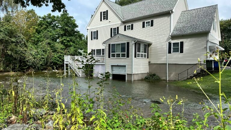 A brook in Leominster, Mass. overflows into the garage of a home.