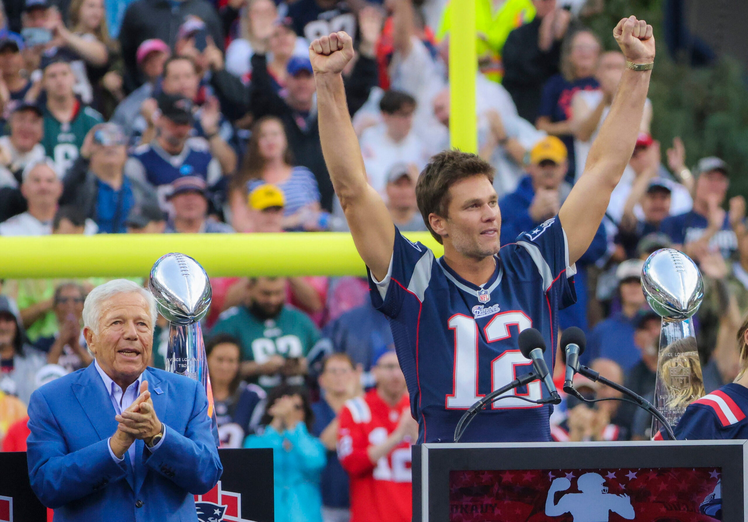 Tom Brady speaking during a half time celebration in Brady’s honor as team owner Robert Kraft applaudes during their game against the Philadelphia Eagles at Gillette Stadium. 